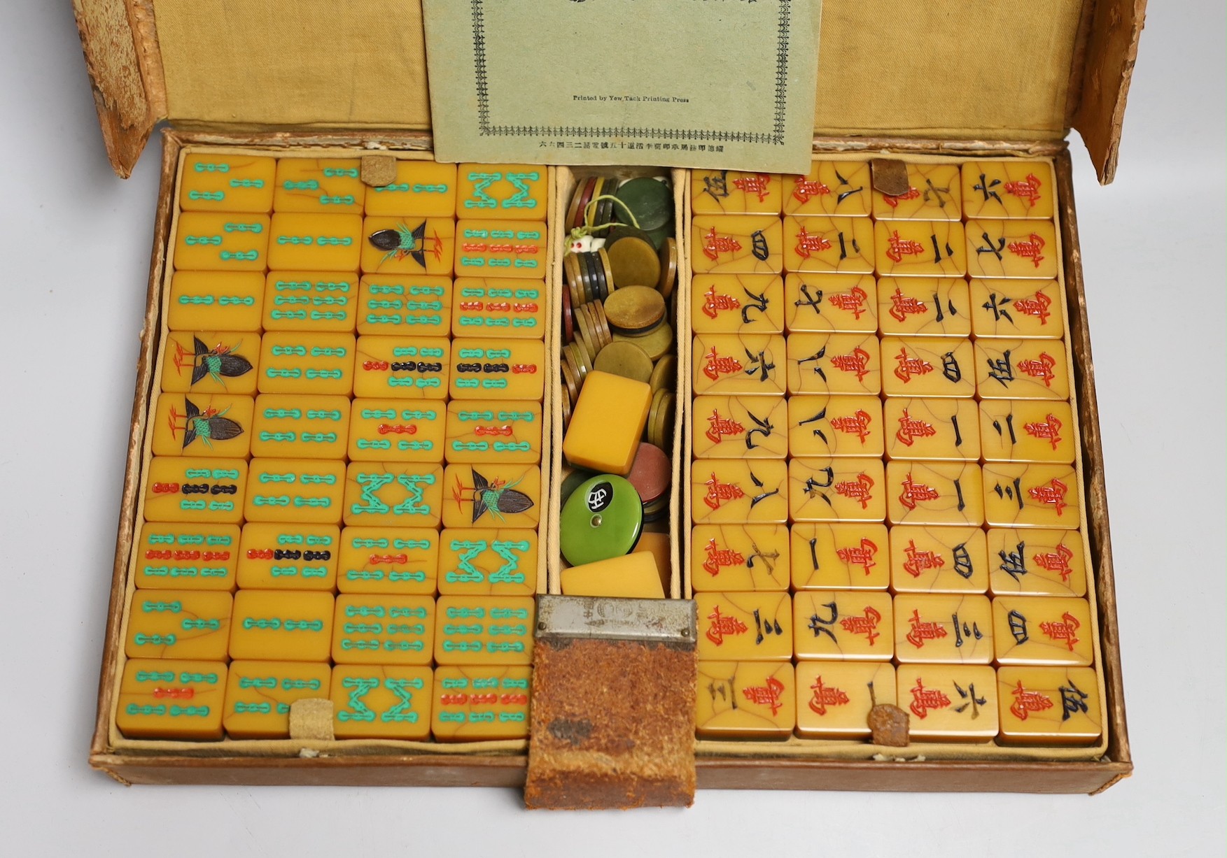 A leather cased Bakelite mahjong set